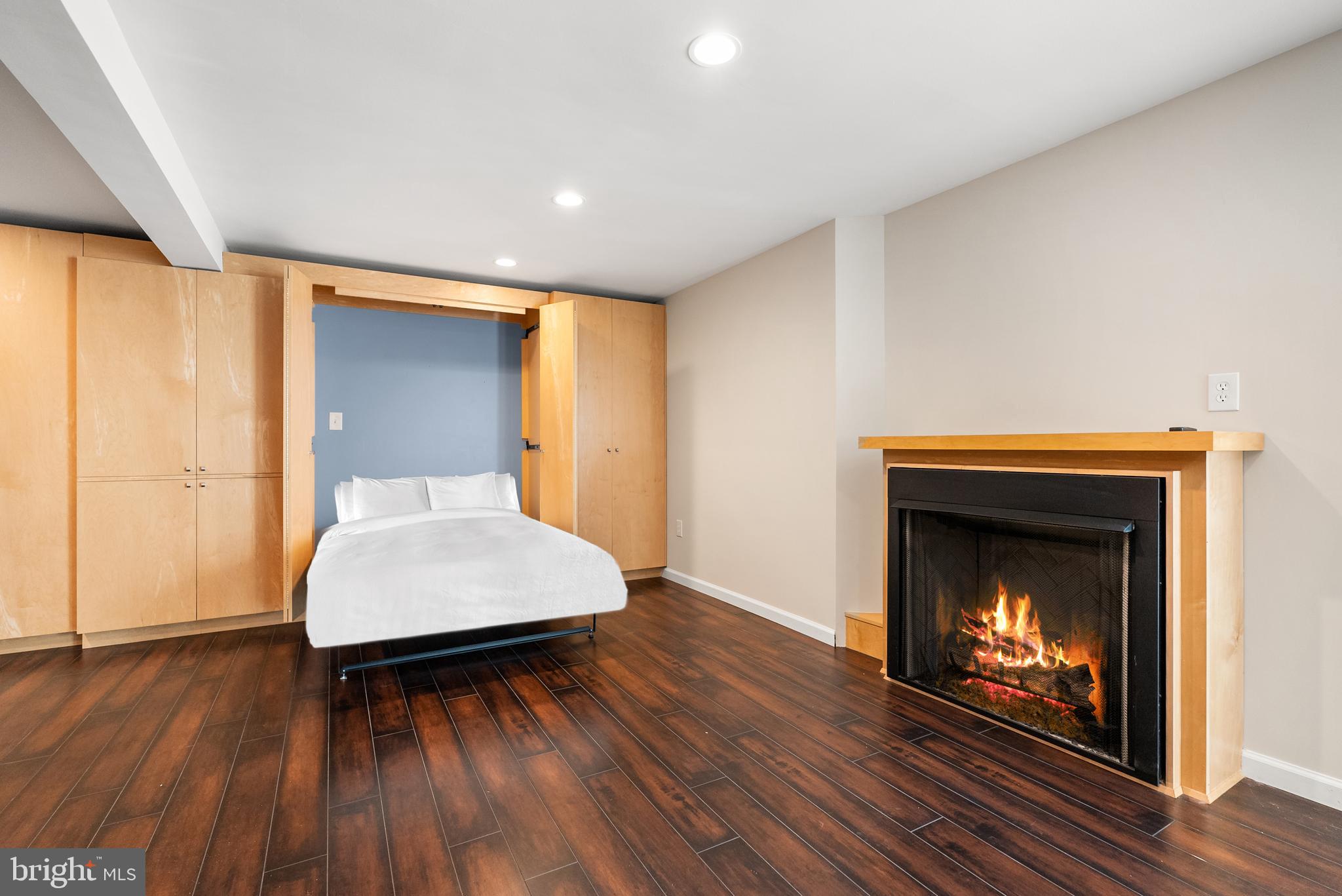 6417 Tone Drive Bethesda, MD 20817 - Photo 42 of 50 a living room with a fireplace and wooden floor