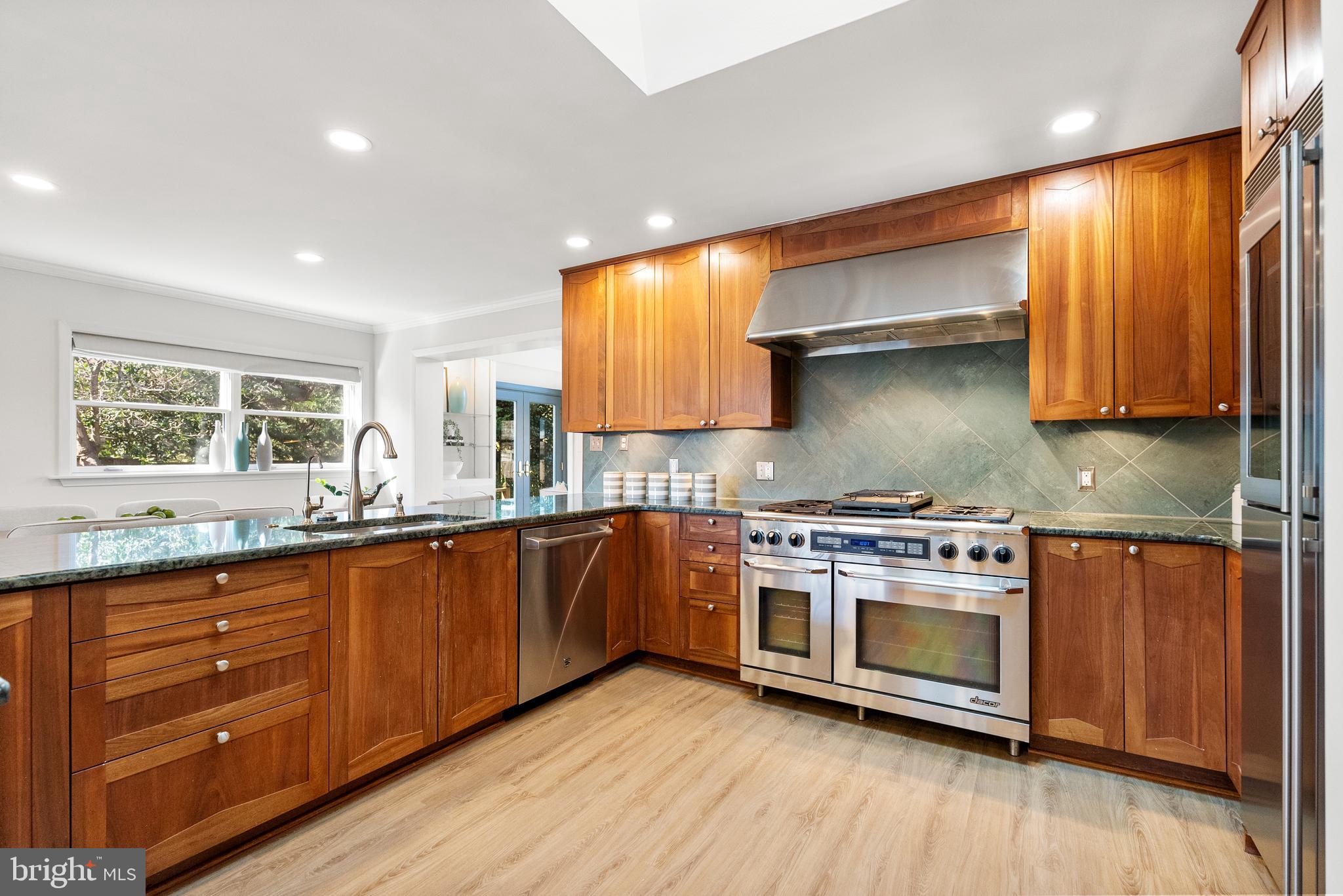6417 Tone Drive Bethesda, MD 20817 - Photo 7 of 50 a kitchen with stainless steel appliances granite countertop wooden cabinets stove and sink