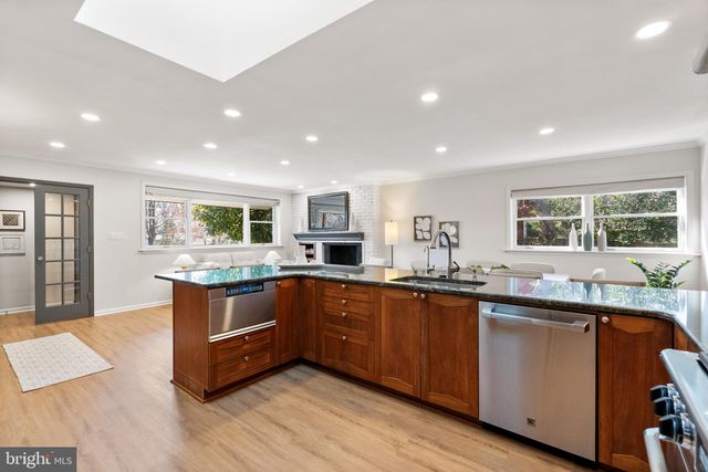 a kitchen with granite countertop a sink and cabinets