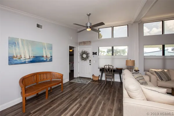 a living room with furniture and wooden floor