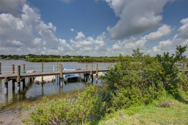 a view of a lake with outdoor seating