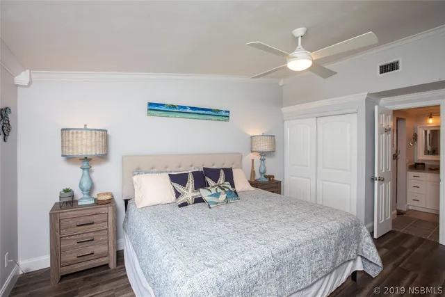 a bedroom with bed and a night stand