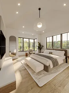 a large bedroom with a large bed and a large window