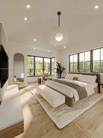 a large bedroom with a large bed and a large window