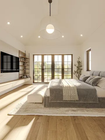 a spacious bedroom with a large bed and a flat screen tv
