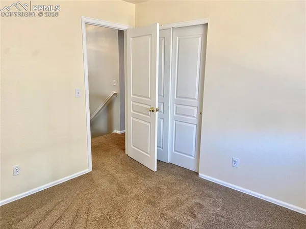 an empty room with an entrance to other room