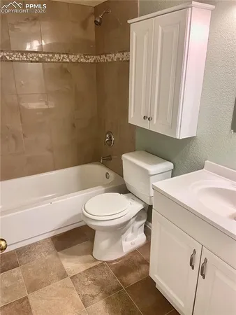 a bathroom with a toilet a sink and bathtub