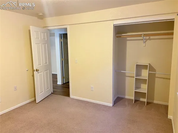 a view of a room with wooden floor and cabinet