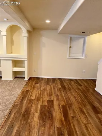 a view of empty room with fireplace