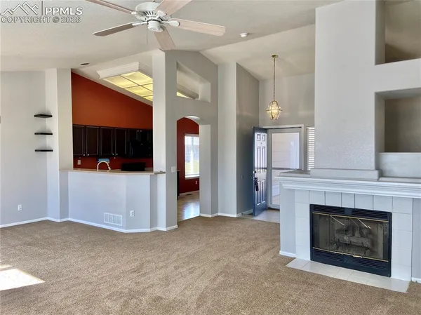 a living room with furniture and a fireplace
