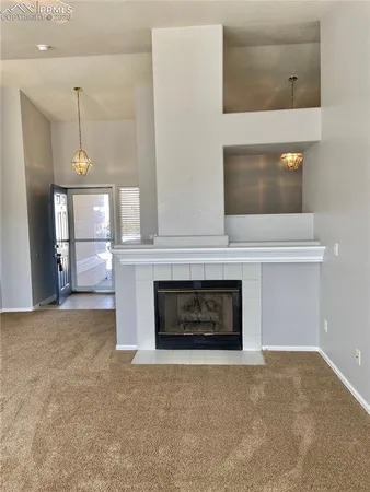 a view of a livingroom with a fireplace and window