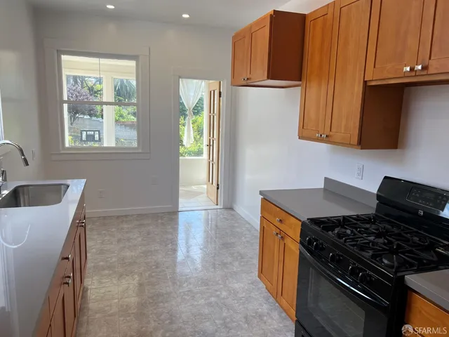 a kitchen with granite countertop a stove and a sink