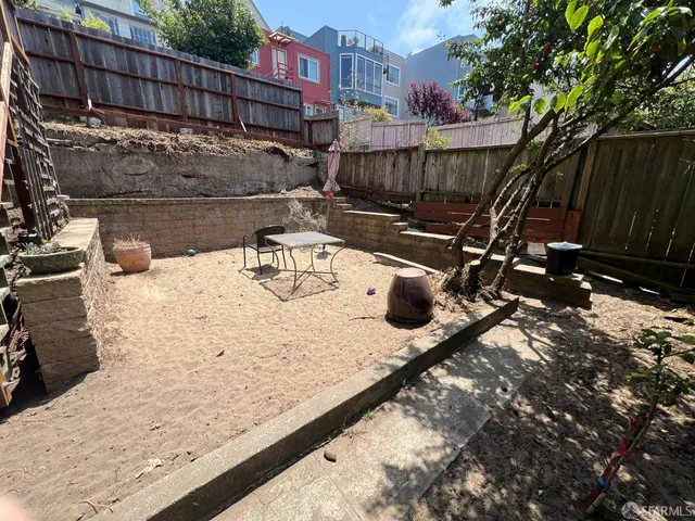 a view of a backyard with sitting area