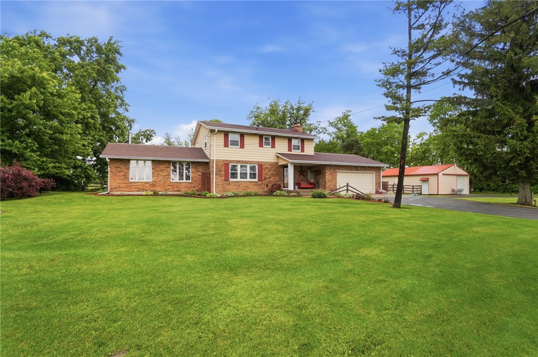 4170 Johnson Road Springfield, OH 45502 - Photo 6 of 54 A spacious home with a verdant front lawn and convenient attached garage.