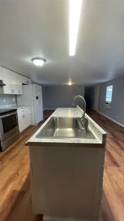 a stove top oven sitting inside of a kitchen