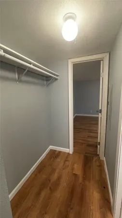 a view of a room with wooden floor