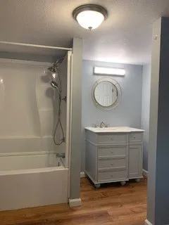 a view of an empty room and wooden floor