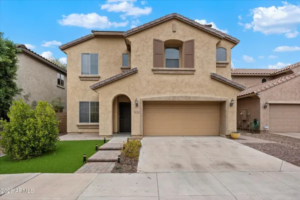 a front view of a house with a yard and garage