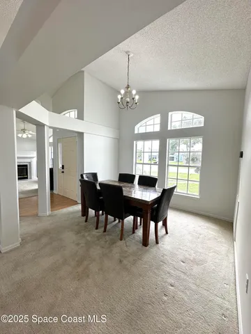 a dining room with furniture and window