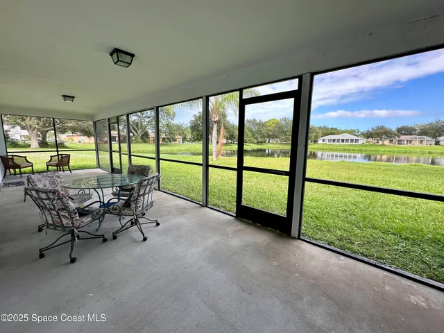 a view of a city from a patio with a table chairs and a patio