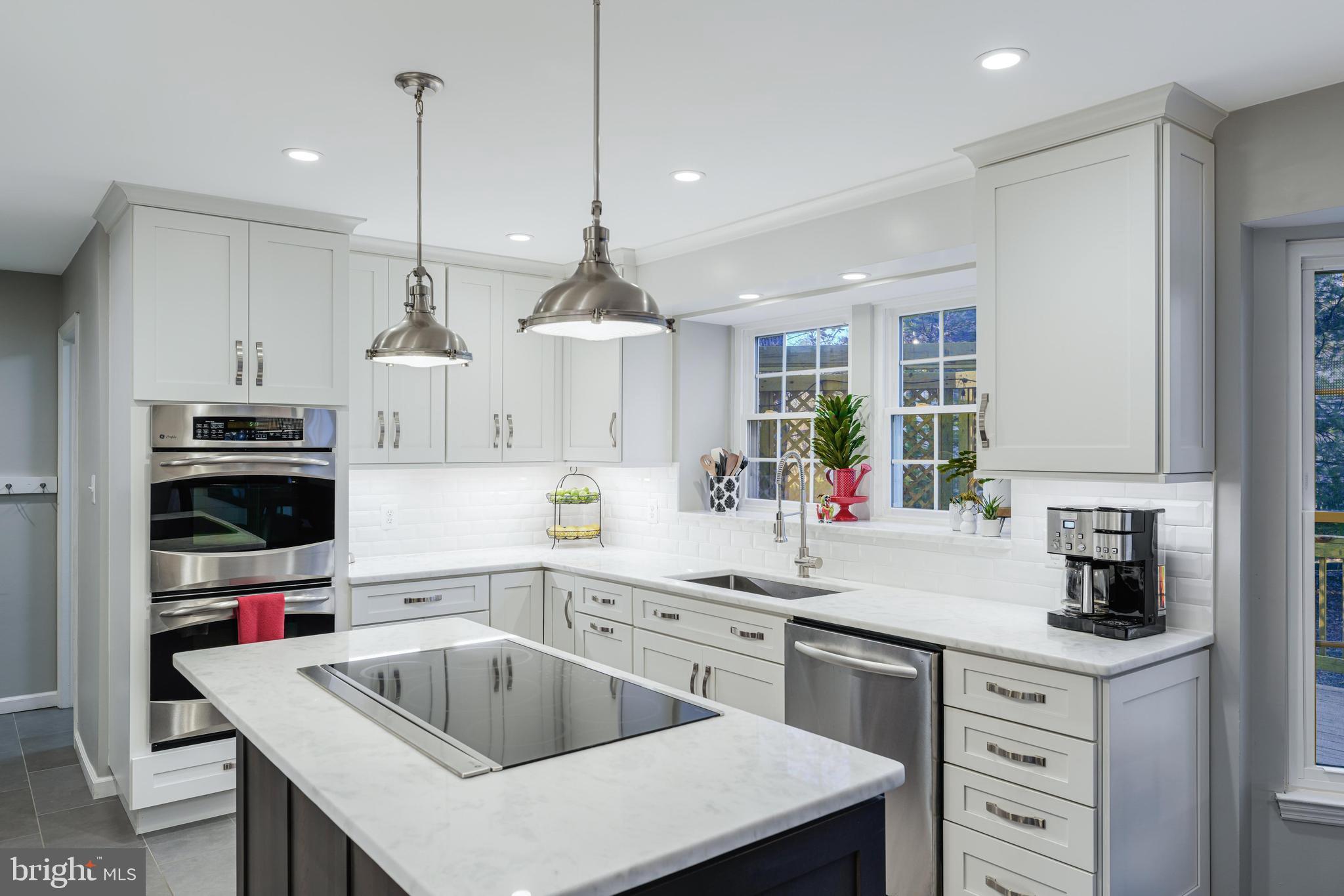 6900 Confederate Ridge Lane Centreville, VA 20121 - Photo 24 of 69 a kitchen with a sink a stove and chairs