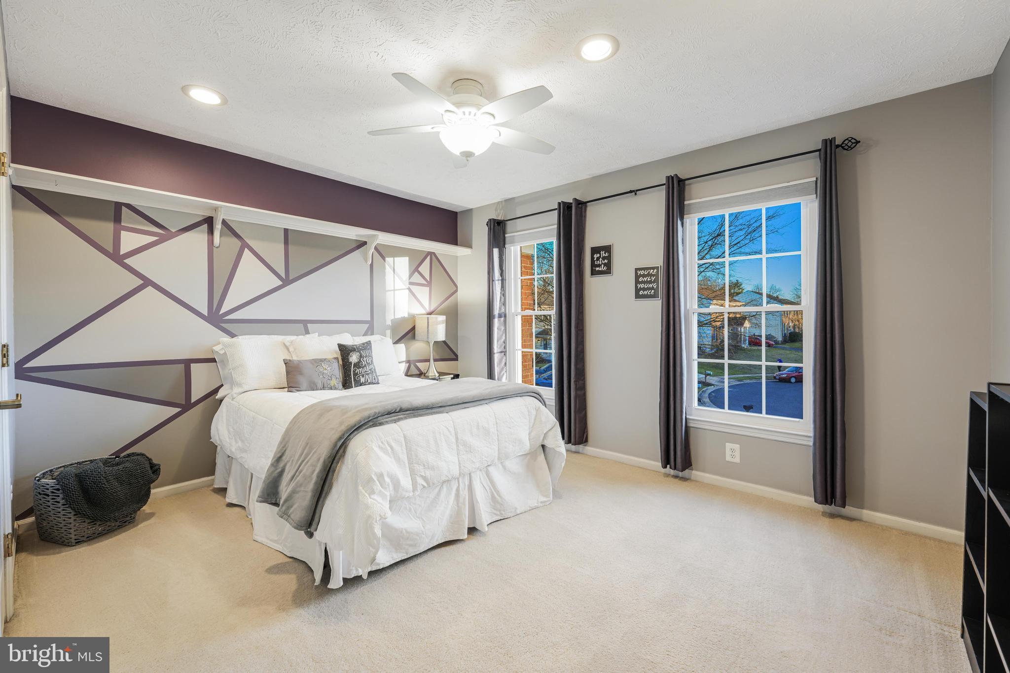 6900 Confederate Ridge Lane Centreville, VA 20121 - Photo 43 of 69 a spacious bedroom with a large bed and a chandelier