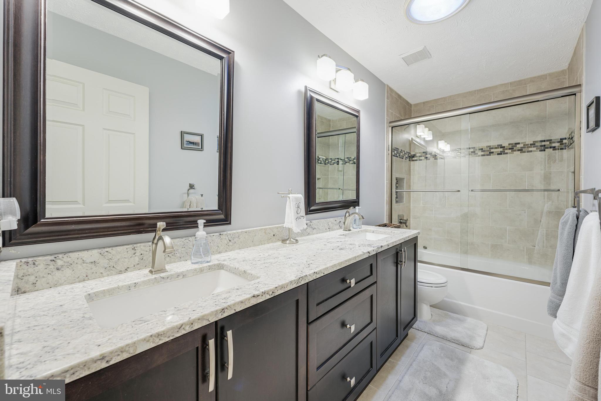 6900 Confederate Ridge Lane Centreville, VA 20121 - Photo 45 of 69 a bathroom with a granite countertop sink mirror and double