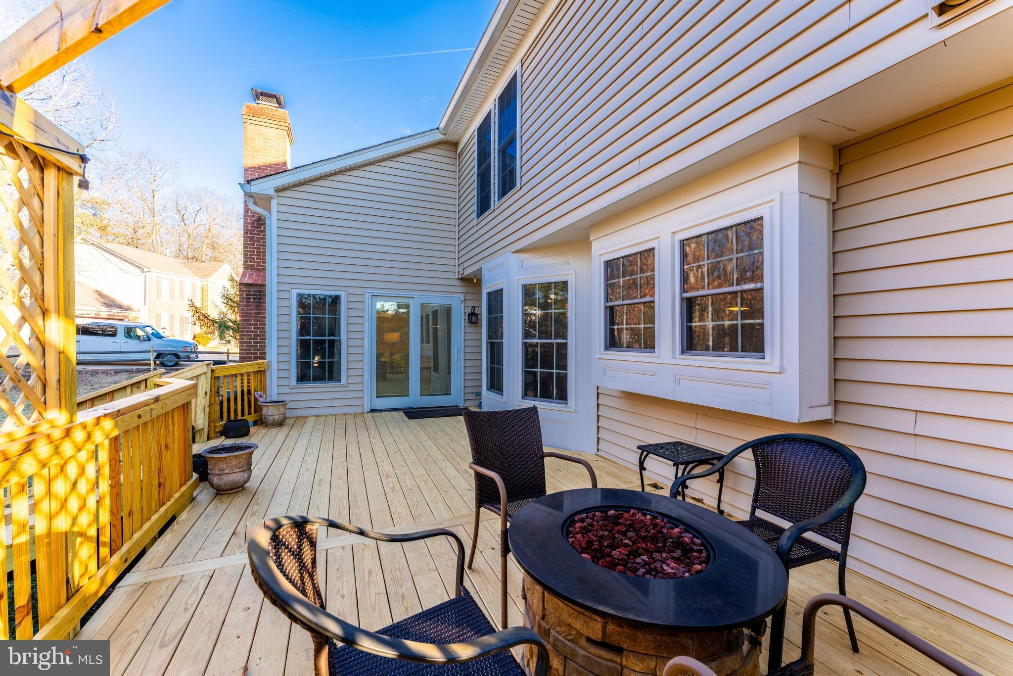 6900 Confederate Ridge Lane Centreville, VA 20121 - Photo 65 of 69 a view of a patio with table and chairs a barbeque with wooden floor and fence