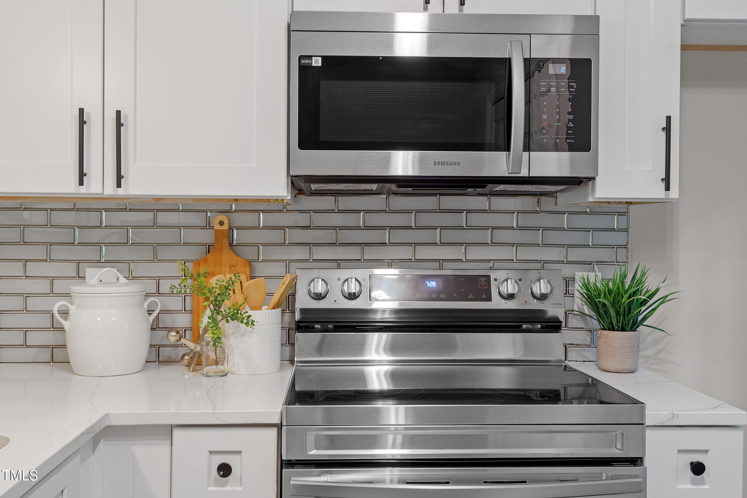 4242 Kaplan Drive Raleigh, NC 27606 - Photo 9 of 30 a kitchen with a stove and a potted plant