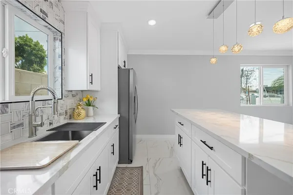 a kitchen with granite countertop a sink and a window