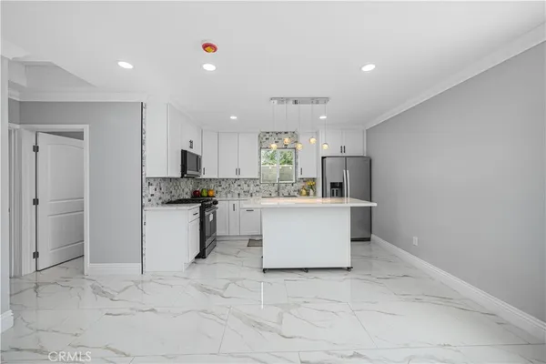 a kitchen with white cabinets and white appliances