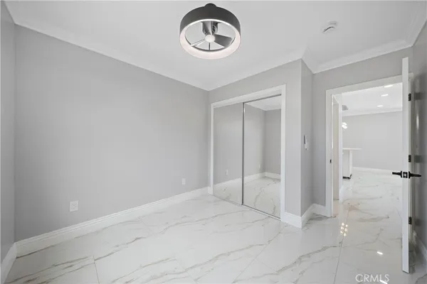 a view of an empty room and a bathroom
