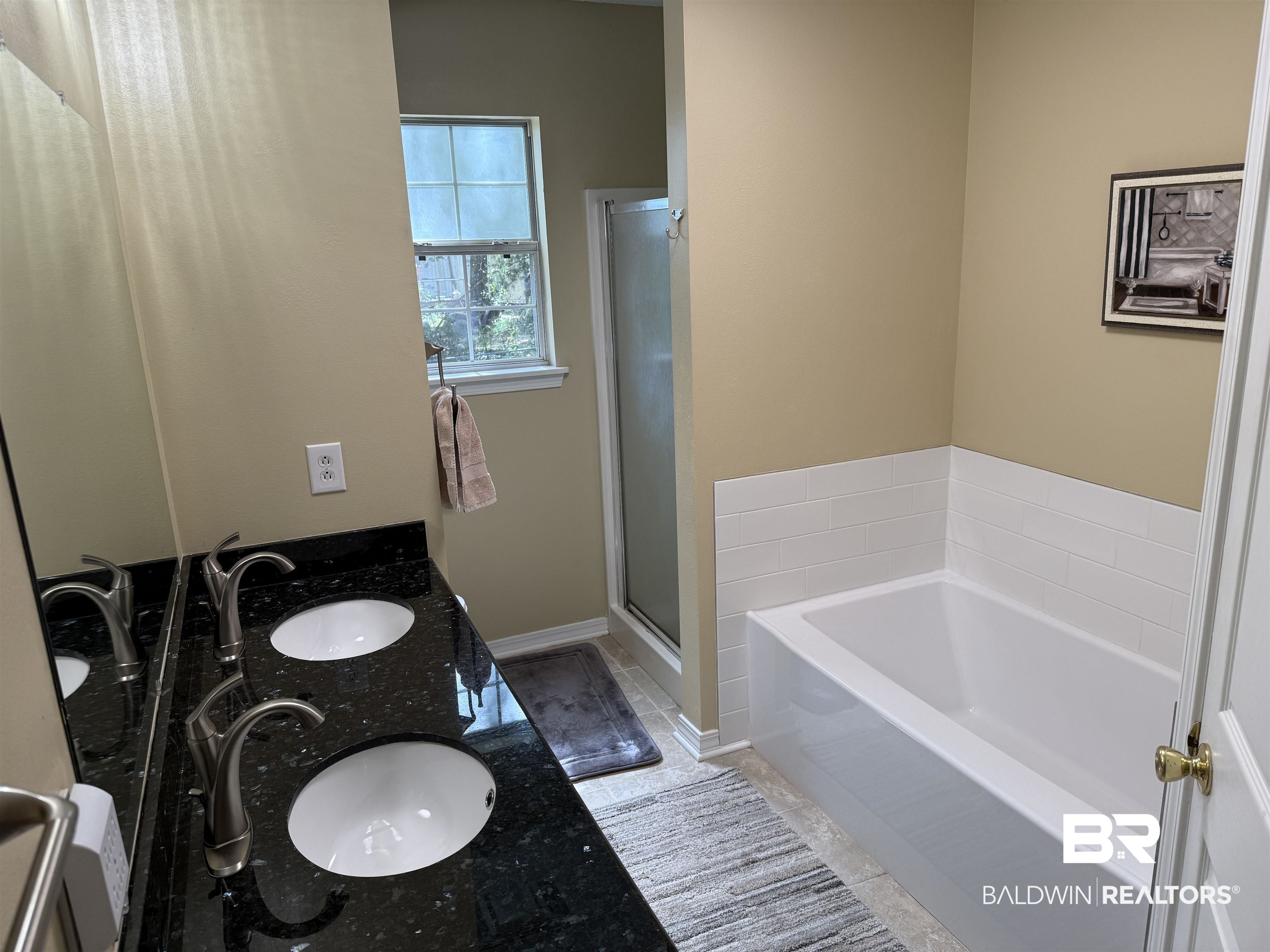14601 Trawick Road Stapleton, AL 36578 - Photo 19 of 37 Full bathroom with a bath, a stall shower, and double vanity