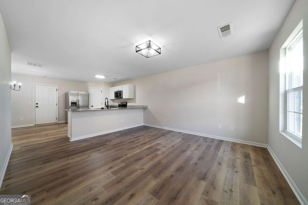 21 Walton Creek Drive Southwest Rome, GA 30165 - Photo 4 of 26 a view of a kitchen with wooden floor and a window