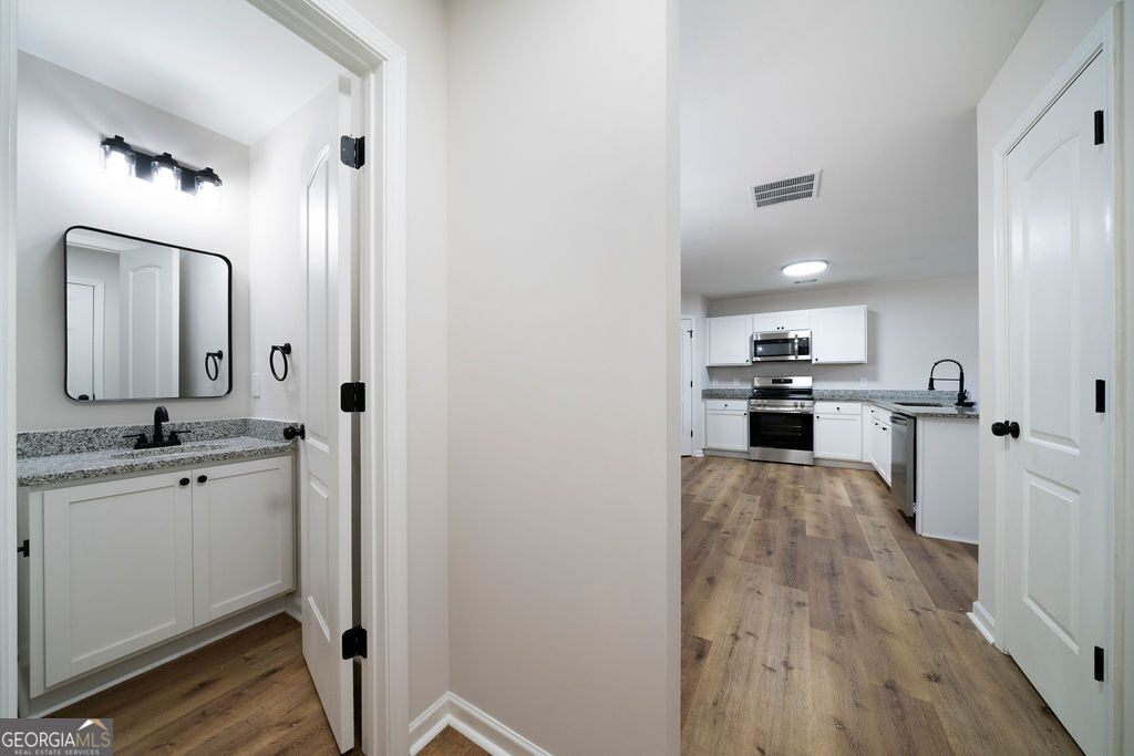 21 Walton Creek Drive Southwest Rome, GA 30165 - Photo 9 of 26 a view of a kitchen with wooden floor and electronic appliances
