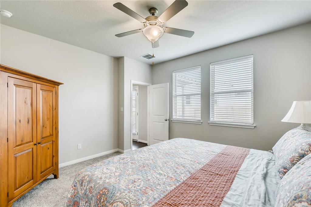 105 Tucana Street Georgetown, TX 78628 - Photo 7 of 17 Bedroom featuring light colored carpet and a ceiling fan on the main floor