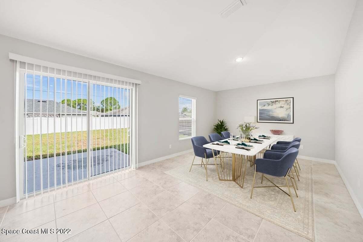 1111 Ver Circle Northeast Palm Bay, FL 32905 - Photo 14 of 30 a dining room with furniture and floor to ceiling window