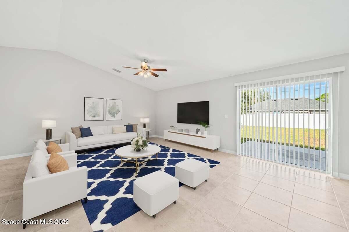 1111 Ver Circle Northeast Palm Bay, FL 32905 - Photo 16 of 30 a living room with furniture and a flat screen tv