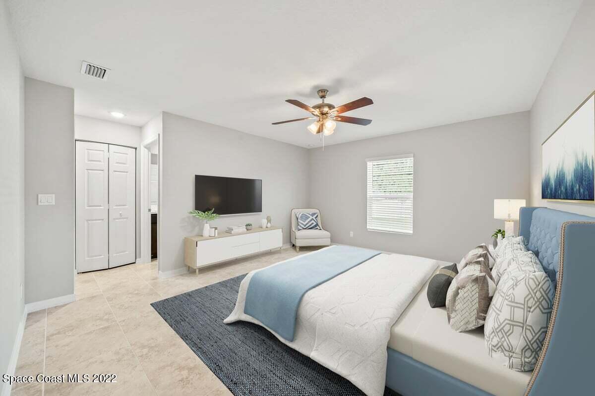 1111 Ver Circle Northeast Palm Bay, FL 32905 - Photo 19 of 30 a bedroom with a bed and a television