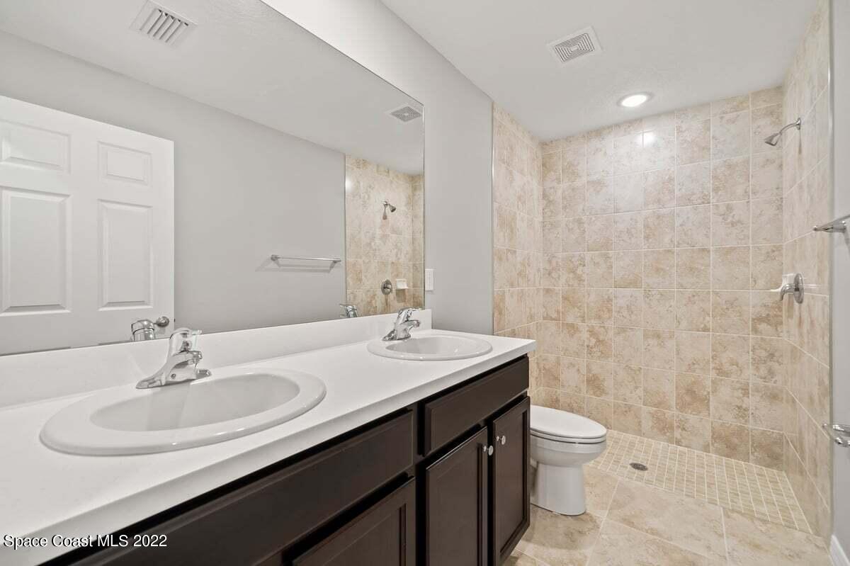 1111 Ver Circle Northeast Palm Bay, FL 32905 - Photo 20 of 30 a bathroom with a sink toilet and shower