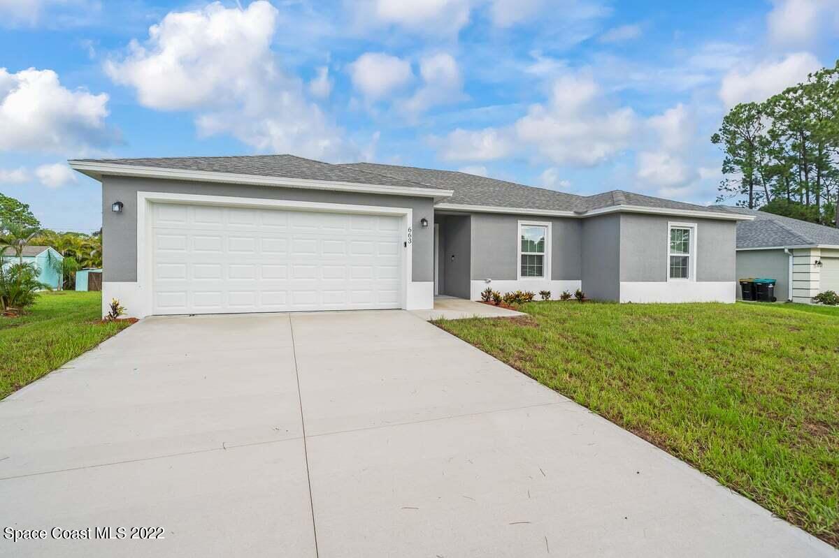 1111 Ver Circle Northeast Palm Bay, FL 32905 - Photo 2 of 30 a view of house and outdoor space with yard