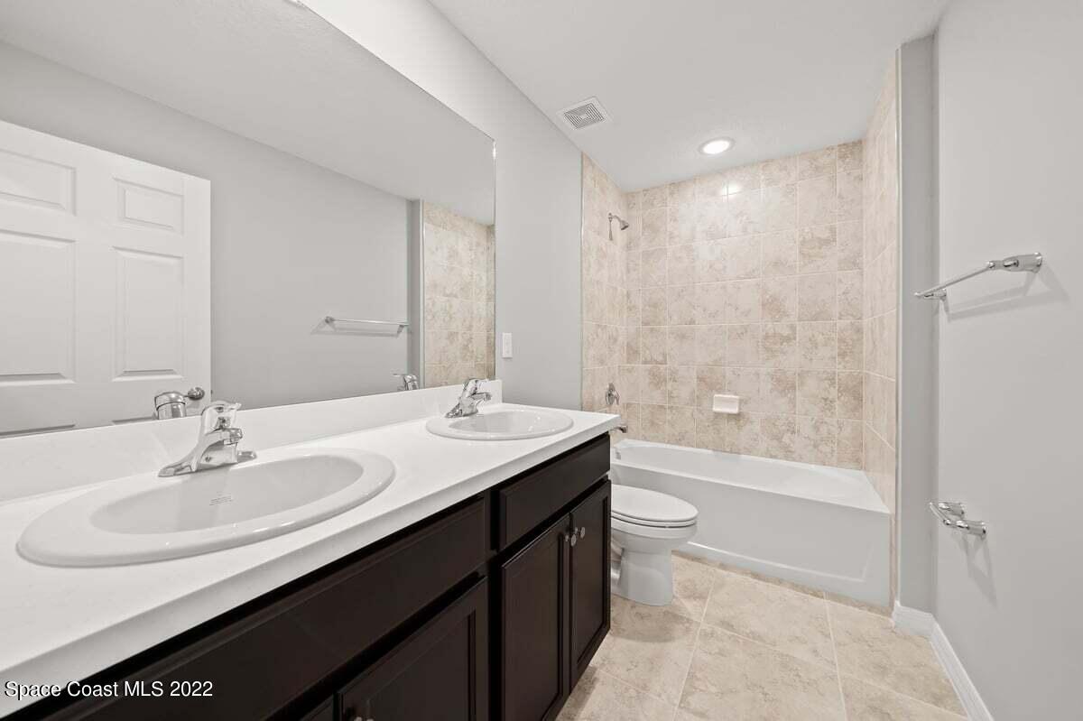 1111 Ver Circle Northeast Palm Bay, FL 32905 - Photo 25 of 30 a bathroom with a sink double vanity granite tub shower and a mirror