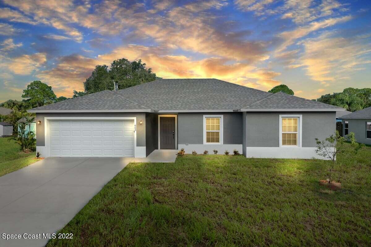 1111 Ver Circle Northeast Palm Bay, FL 32905 - Photo 29 of 30 front view of a house with a yard