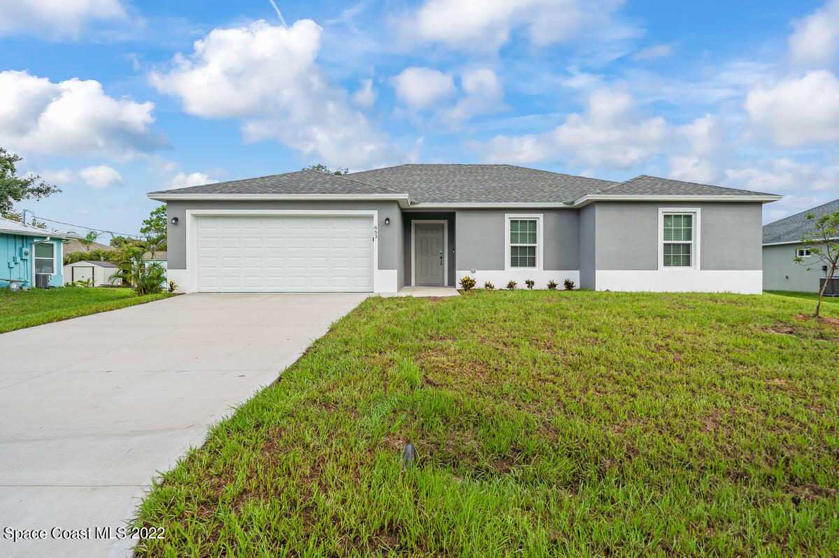 1111 Ver Circle Northeast Palm Bay, FL 32905 - Photo 3 of 30 a front view of house with yard and green space