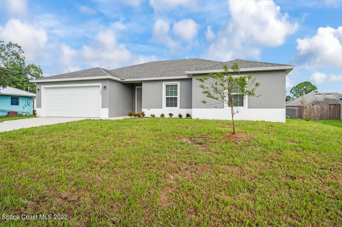 1111 Ver Circle Northeast Palm Bay, FL 32905 - Photo 4 of 30 a front view of house with yard and green space
