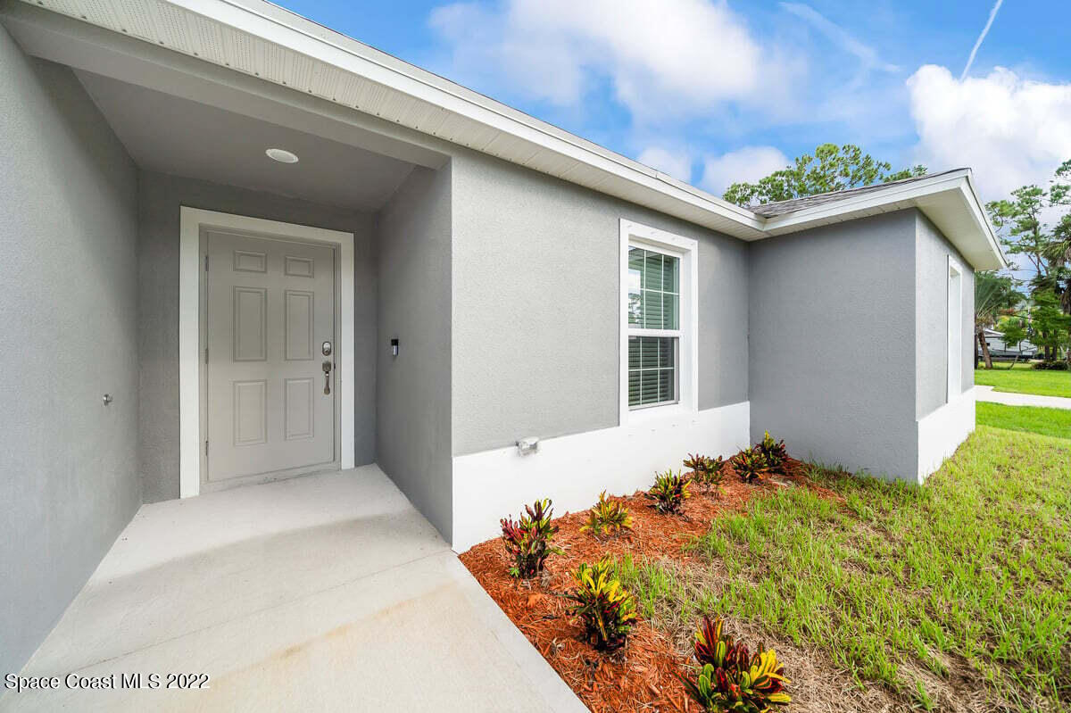 1111 Ver Circle Northeast Palm Bay, FL 32905 - Photo 5 of 30 a bedroom with bed and a window