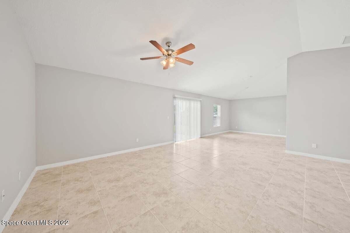 1111 Ver Circle Northeast Palm Bay, FL 32905 - Photo 7 of 30 an empty room with windows and fan