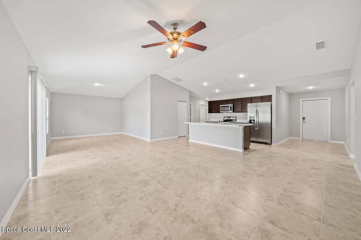 1111 Ver Circle Northeast Palm Bay, FL 32905 - Photo 8 of 30 a view of kitchen with refrigerator and ceiling fan