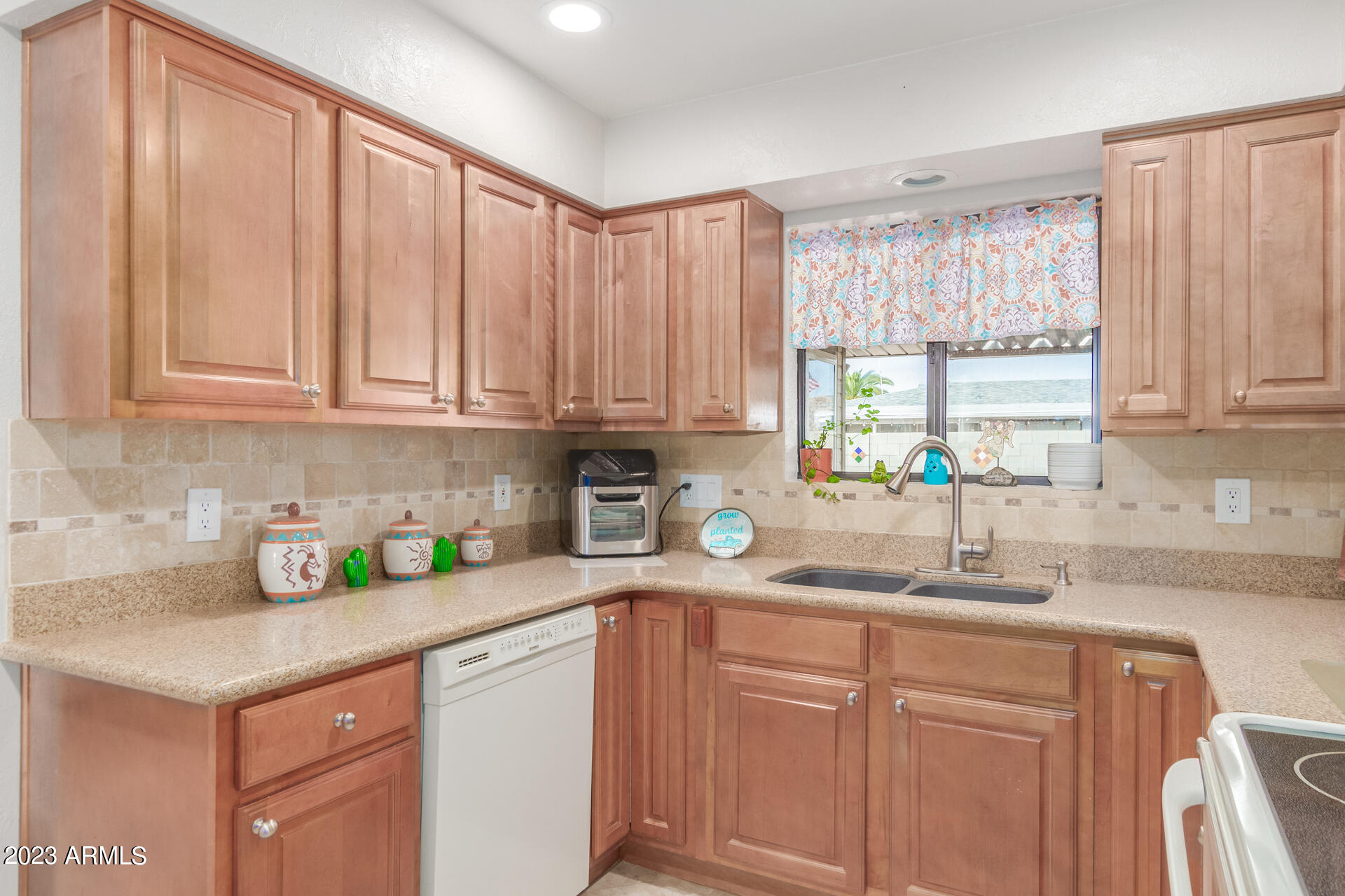 5646 East Decatur Street Mesa, AZ 85205 - Photo 8 of 51 a kitchen with stainless steel appliances granite countertop a sink a cabinets and next to a window