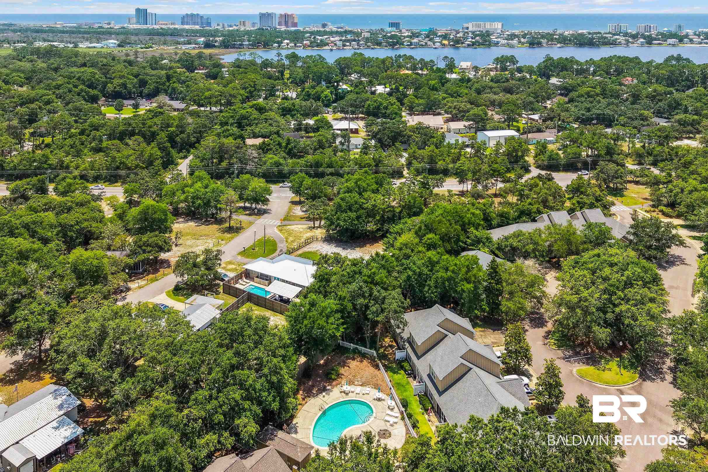 430 West Fort Morgan Road, Unit 704 Gulf Shores, AL 36542 - Photo 31 of 35 Aerial perspective showcasing multiple residential structures amidst a dense canopy of mature trees
